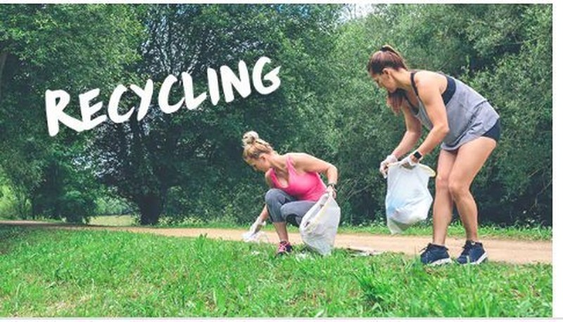 Two women picking up recycling outside Two women picking up recycling outside