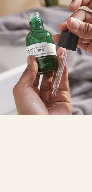 Tea Tree Solution being applied to palm of hand Tea Tree Solution being applied to palm of hand