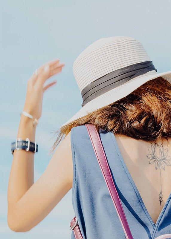 Woman wearing a hat and summer attire