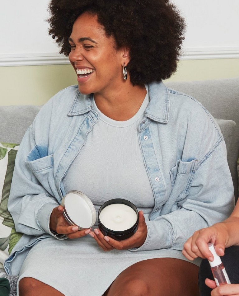 Independent Consultant laughing with The Body Shop products Independent Consultant laughing with The Body Shop products