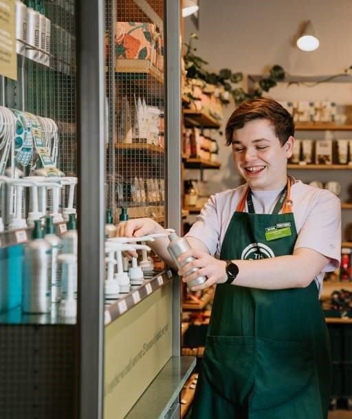 The Body Shop employee at refill station