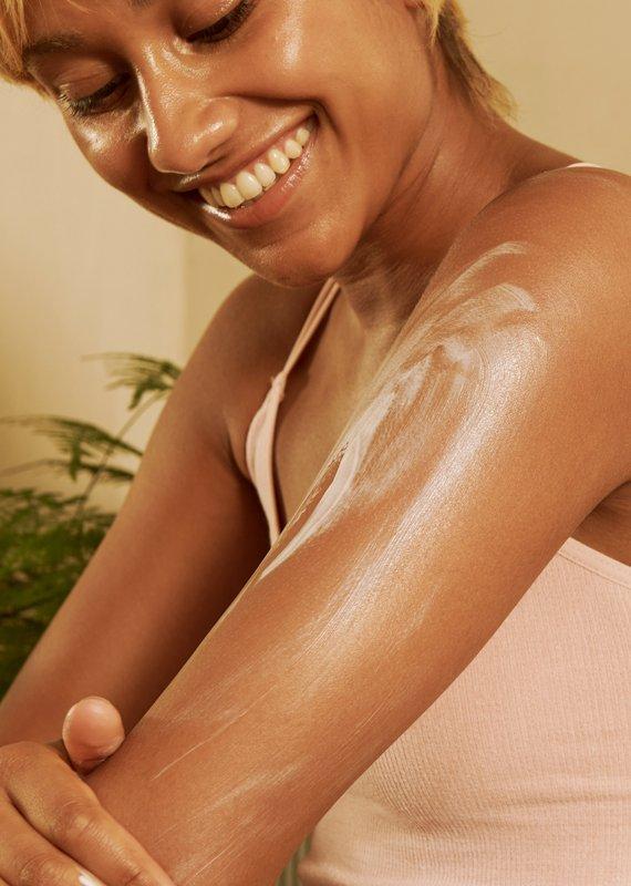 Model applying body yogurt to arm