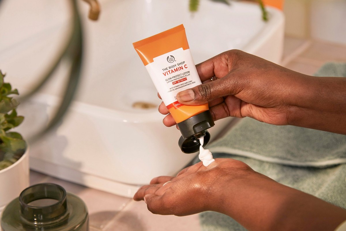 Hands squeezing The Body Shop Vitamin C Lotion