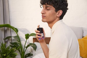 Man spraying The Body Shop White Musk Eau De Toilette Man spraying The Body Shop White Musk Eau De Toilette