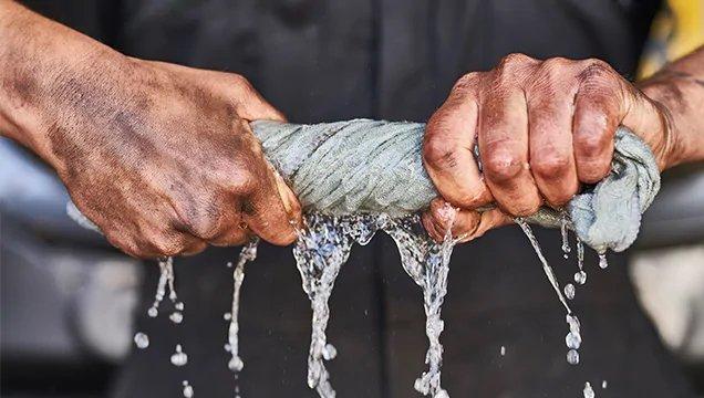 Man wringing water from cloth