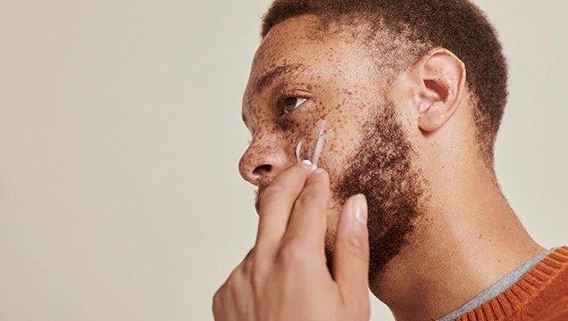 Man applying face moisturiser